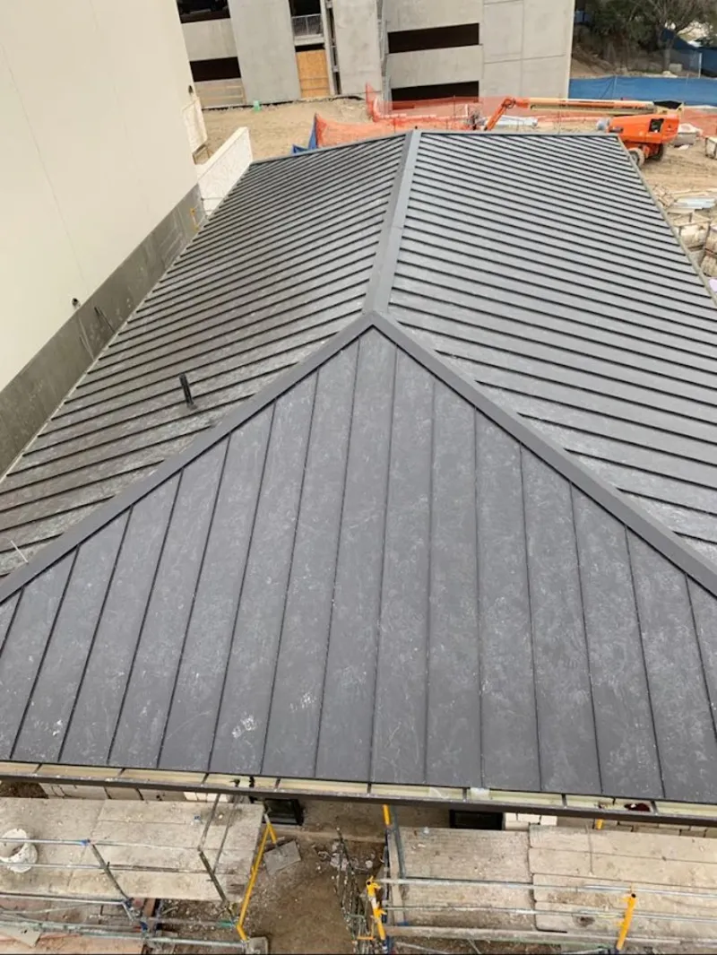 Commercial metal roof construction with crane equipment in Germantown