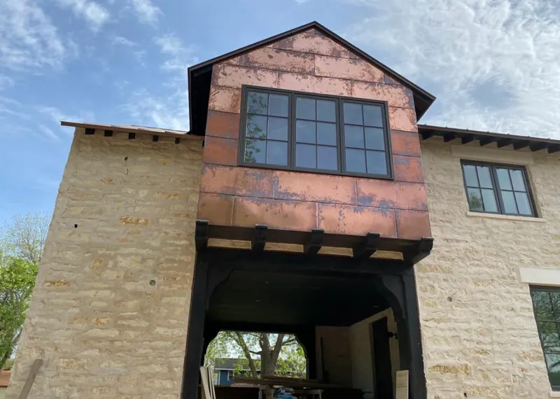 Copper metal panel facade on a stone building for Roof Repair in Germantown